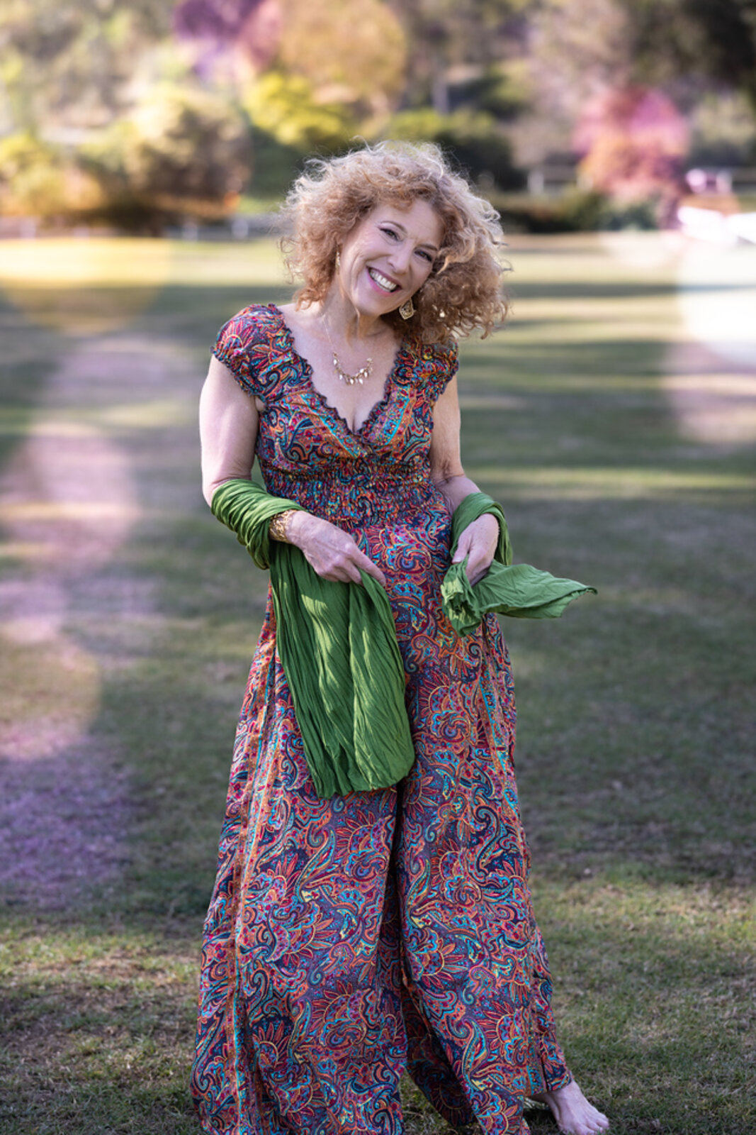 Tsilah Burman smiling outdoors in a floral dress